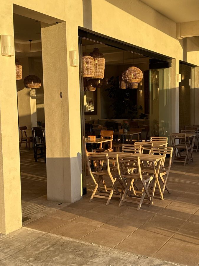 The front of Obsidian 17 in golden light, with folding terrace chairs